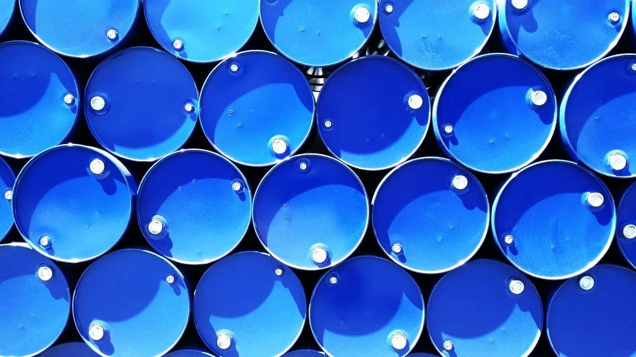 Rows of stacked blue industrial raw-material drums